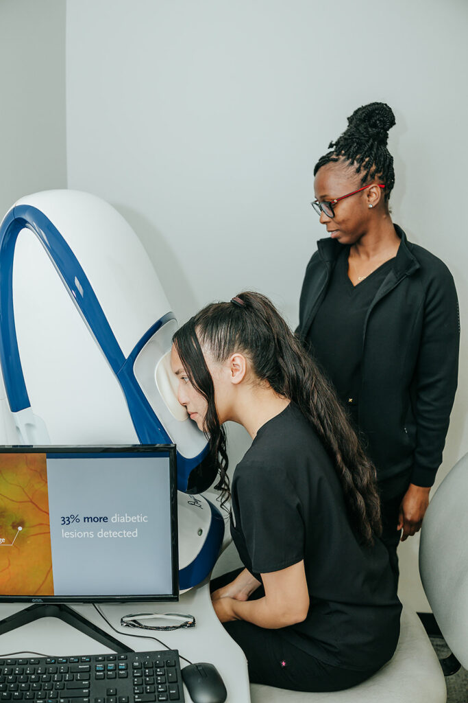 Patient sitting in front of Optos machine