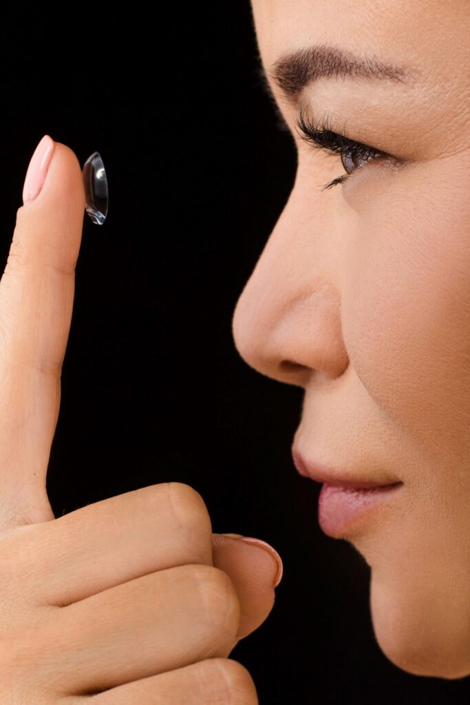 woman putting on contact lens